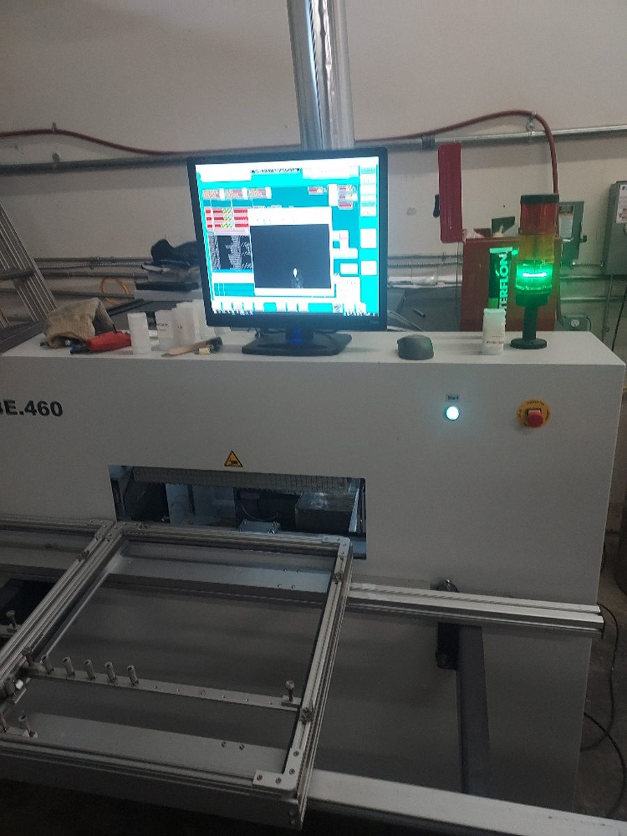 Inline surface-mount production equipment with a process-monitoring display and board-handling conveyor.